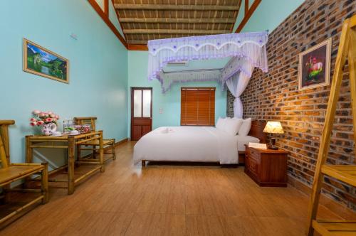 a bedroom with a bed and a brick wall at Tam Coc Moonlight Sweet Home in Ninh Binh