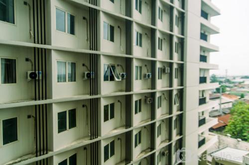 an apartment building with windows and a view at Comfort Studio Apartment at Padina SOHO Residence By Travelio in Tangerang