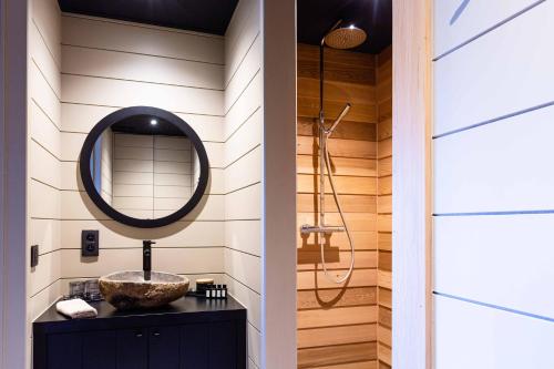 a bathroom with a sink and a mirror at Suites de la vallee 2 in Érezée