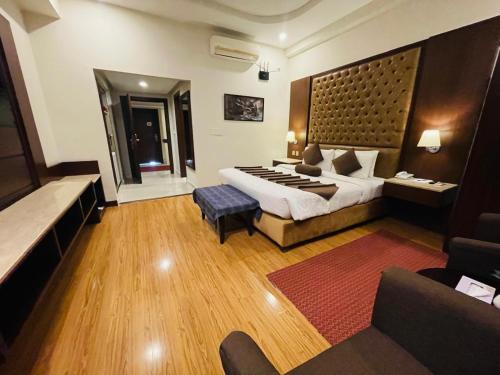 a hotel room with a bed and a couch at Legend Hotel Islamabad in Islamabad
