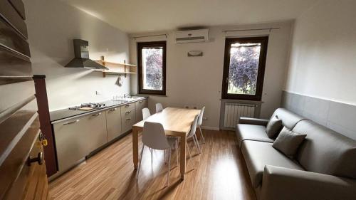 a living room with a couch and a table at AGRITURISMO LA CORTE DEI CAVALIERI in Montefalco