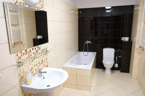 a bathroom with a sink and a toilet at Dom Studenta PUZ w Suwałkach in Suwałki