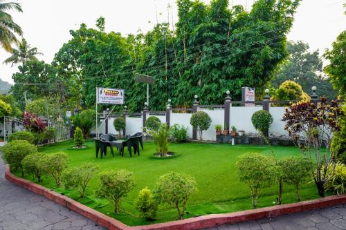 a garden with horses in the middle of a lawn at Athirappilly Ambady Resort in Athirappilly