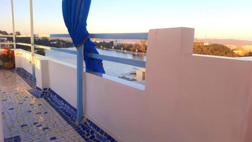 a balcony with a window with a view of a river at Gladden Villa in Udaipur
