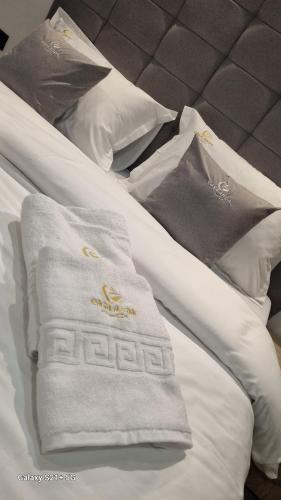 a bed with a blanket and a towel on it at Casa Anda in Pucioasa