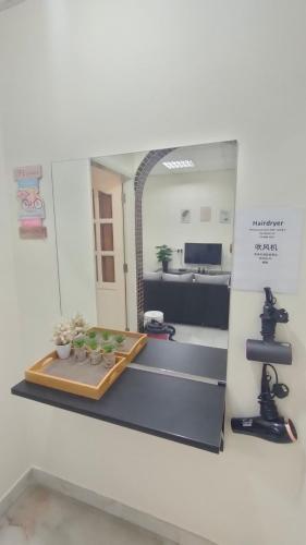 a mirror on the wall of a room with a table at 33 HOMESTAY 4 Room 5 MINUTE TO LEANING TOWER in Teluk Intan
