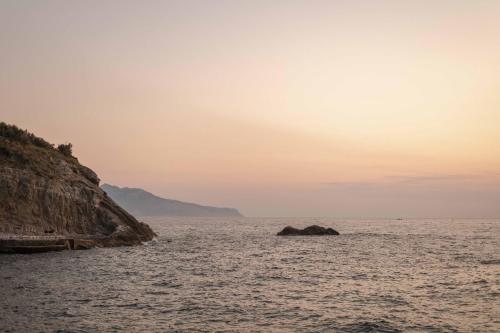 a view of the ocean at sunset at Maya Beach Resort in Massa Lubrense
