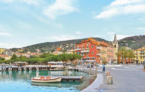 a small boat in a body of water with buildings at Stunning Apartment In Fosdinovo in Fosdinovo