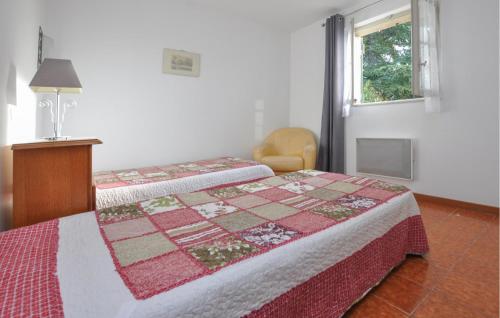 a bedroom with a bed with a quilt on it at Awesome Home In Fayence With Wifi in Fayence