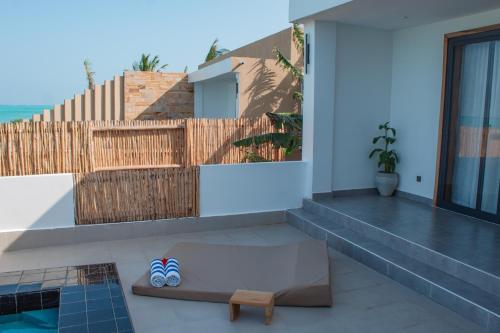 a pair of shoes sitting on the balcony of a house at Oasis Blu Beach Resort-Adults Only in Nungwi