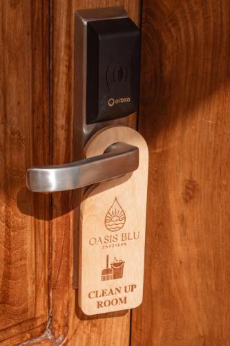 a wooden door lock with a sign on it at Oasis Blu Beach Resort-Adults Only in Nungwi