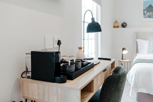a living room with a tv on a wooden desk at Dixon House in De Waterkant by Cape Finest in Cape Town