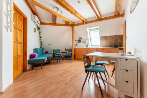 a kitchen and dining room with a table and chairs at Csermák Lak in Veszprém