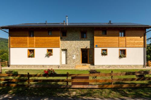 a house with a fence in front of it at B&B Apartments Burić Plitvice Lakes in Plitvička Jezera