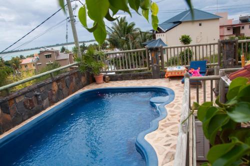 a swimming pool on the balcony of a house at Sunset Villa in La Gaulette
