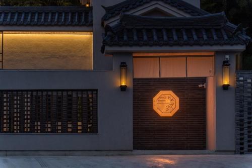 a building with a garage door with a sign on it at Hoshiga Pool Villa in Yeongcheon