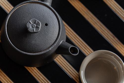 a cup of coffee sitting next to a speaker at Hoshiga Pool Villa in Yeongcheon