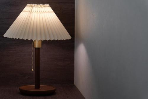 a lamp with a white lamp shade in a room at Hoshiga Pool Villa in Yeongcheon