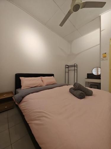 Un dormitorio con una cama grande con ventilador de techo. en Garden Homes Seremban 2 644, en Seremban