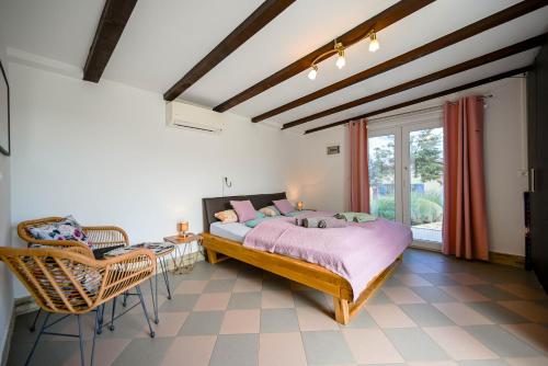 a bedroom with a bed and a table and chairs at Bella di Campo in Rovinj