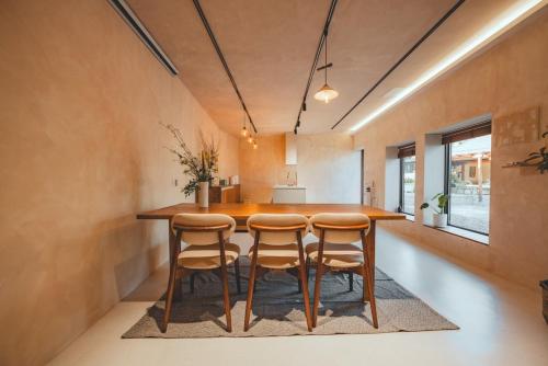 a large kitchen with a wooden table and stools at Gurye Taepyeonghan Daepyeong in Gurye