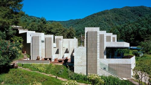 a building with many tall white buildings on a hill at Yang Pyeong HOUSE OF MIND pension in Yangpyeong