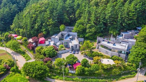 an aerial view of a house in the mountains at Yang Pyeong HOUSE OF MIND pension in Yangpyeong