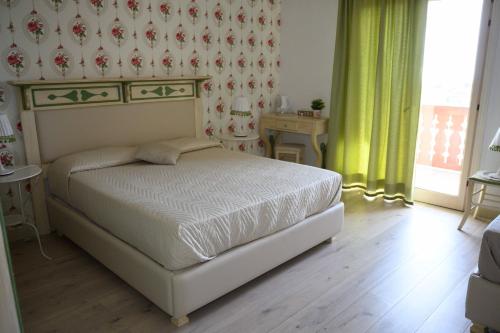 a bedroom with a bed in a room with a window at Etna Casa del Sole in Nicolosi