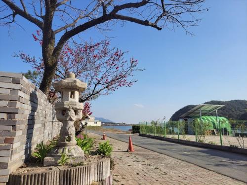 a stone statue on the side of a road at Gyeongju Thousand Year's Miso Pension in Gyeongju