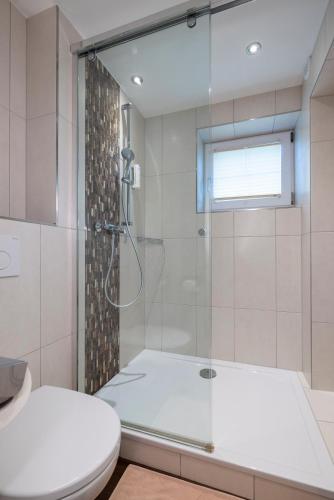 a bathroom with a shower and a toilet at Parkhotel Seefeld in Seefeld in Tirol