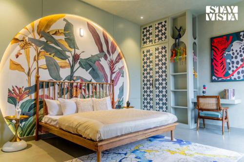 a bedroom with a canopy bed in a room with a mural at StayVista at Urban Escape - 2 Pools, Lawn & WiFi in Jaipur
