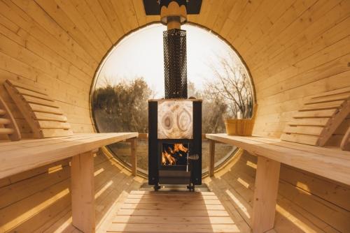 a fireplace in a room with a round window at Gapyeong Hey Finland Sauna Pension in Kŏjŏbi