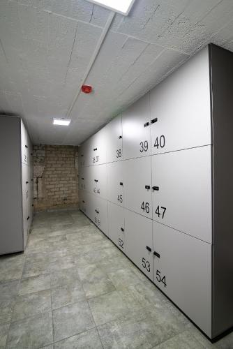 an empty room with white lockers and a red light at Restart in Kaunas