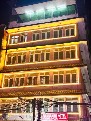 a tall building with a lot of windows at night at Om Mandakini Hotel in Kathmandu