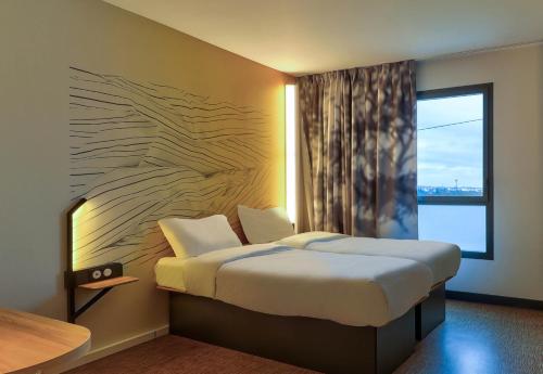 Postel nebo postele na pokoji v ubytování B&B HOTEL Dijon Valmy Toison d'or