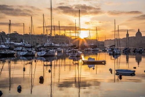 a group of boats in a marina at sunset at Sea Esta 1 in Il-Gżira