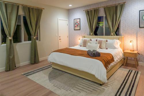 a bedroom with a large bed in a room at Spacious Disneyland Getaway I Game Room, King Suites & EV Access I Sleeps 14 in Midway City