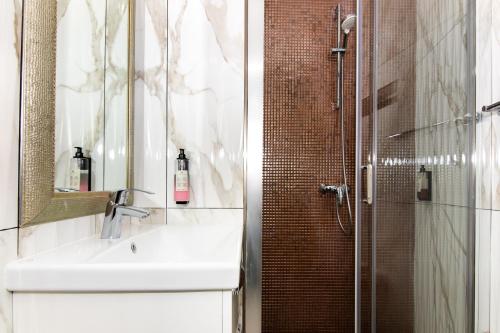 a bathroom with a sink and a shower at Thomas's cozy room with Breakfast in Piran