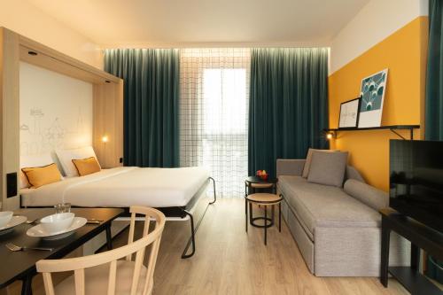 Кровать или кровати в номере Aparthotel Adagio Access Brussels Airport