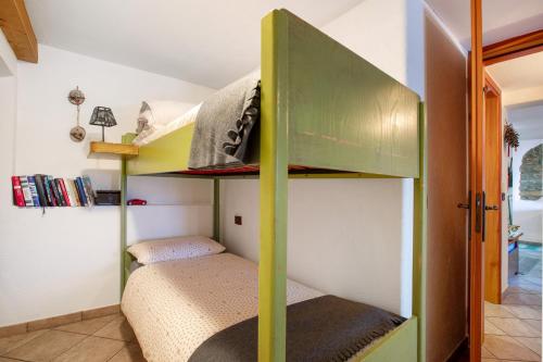a bunk bed in a room with a bunk bed in a room at Maison Cerise Pila in Gressan