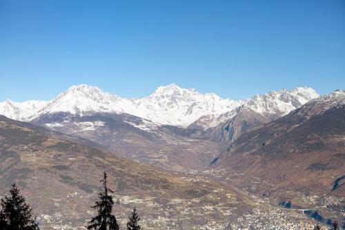 a view of a mountain range with snow covered mountains at Maison Cerise Pila in Gressan