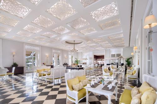 a lobby with white furniture and a checkered floor at Rumah Luwih Bali in Keramas