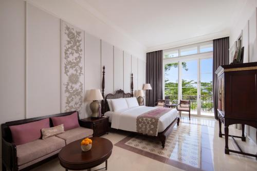 a hotel room with a bed and a couch at Rumah Luwih Bali in Keramas