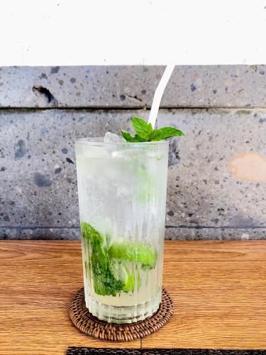 a drink with a green liquid and a straw at Villa JJ and Spa Ubud in Ubud