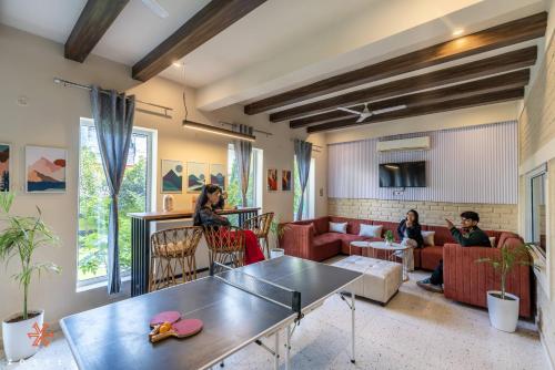 a group of people sitting in a living room at Zostel Rishikesh, Tapovan in Rishīkesh