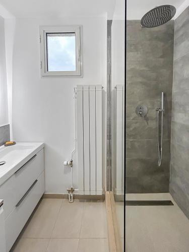 une salle de bain avec une douche avec une porte vitrée dans l'établissement Spacieux, Wi-Fi, à 2 min à pied du Lac de Créteil, à Créteil