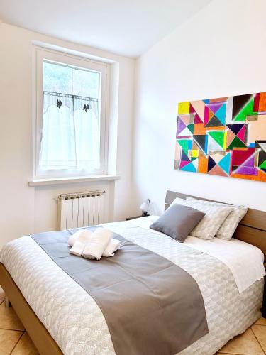 a bedroom with a large bed with a painting on the wall at La Villetta in Scheggino