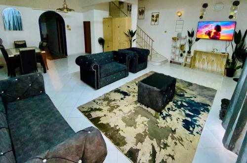a living room with two couches and a rug at booking homestay manjung 300mbps wifi in town in Seri Manjung