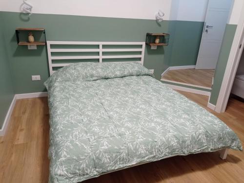 a bed with a gray comforter in a bedroom at Unmei Home in Rome