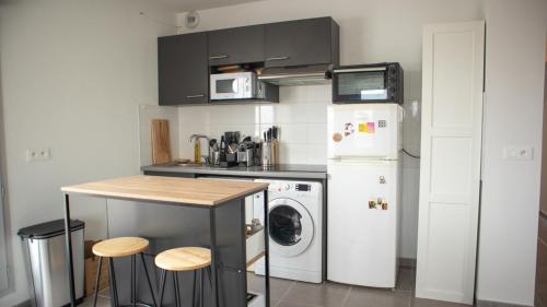 Il comprend une cuisine équipée d'un réfrigérateur et d'un lave-linge/sèche-linge. dans l'établissement Rooftop avec vue sur les Pyrénées et jacuzzi, au pied du zenith, à Toulouse